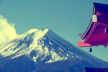 Mount Fuji with snowy on the top over blue sky background with red tower temple, Japan. - Powered by Adobe