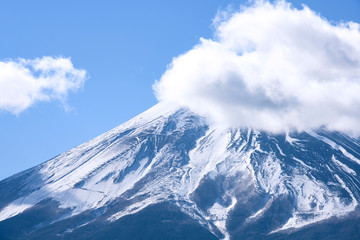 Beautiful Fuji Mountain top view with snow and clouds covered over blue sky winter, Japan