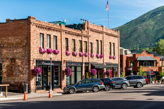 Aspen, USA - July 6, 2019: Historic Downtown Outdoor Summer Street In Colorado With Brick Architecture And Flower Decorations