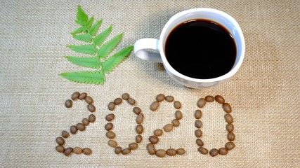 cup of coffee and beans on burlap background