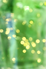 yellow blurry lights of garlands on a green background. soft christmas tree holiday light