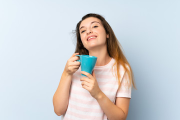 Young brunette girl holding a cup of coffee over isolated background