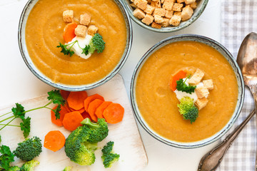 Cream vegetable soup broccoli, carrot, cauliflower with croutons. Vegetarian healthy food on light background