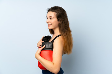 Fototapeta na wymiar Young brunette girl with boxing gloves over isolated background