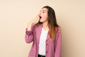 Young brunette girl with blazer over isolated background yawning and covering wide open mouth with hand