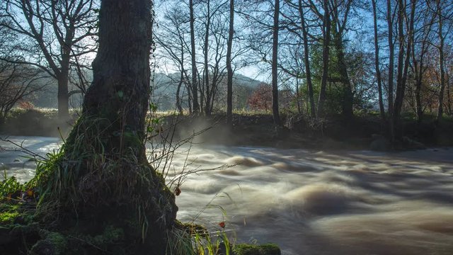 Time lapse, River Esk in Flood with mist hanging over water
