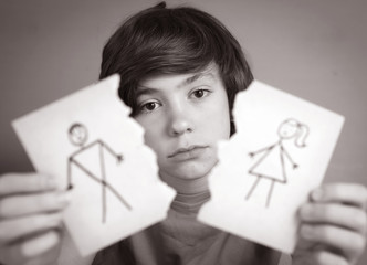 boy hold mom and dad drawing torn apart