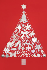 Abstract Christmas tree decoration with silver joy sign & white baubles & ornaments on red background. Traditional theme with symbols for the festive season.