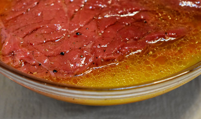 raw beef steak soaked in sauce, fragment 	