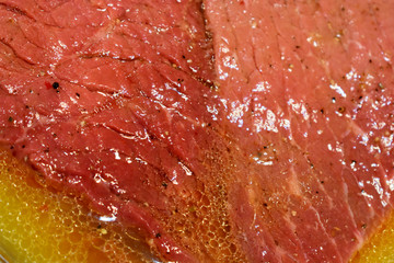 raw beef steak soaked in sauce, fragment 	