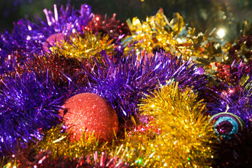 Obraz na płótnie Canvas Multicolored Christmas tinsel and balls background