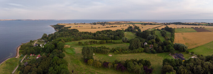 Aerial view of Sankt Ibb golf course on the island Ven in southern Sweden during a summer sunrise. 