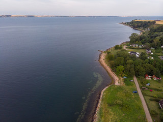 Aerial view of Husvik on Ven island in southern Sweden an early morning in summer during sunrise. 
