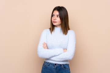 Young woman over isolated background with confuse face expression