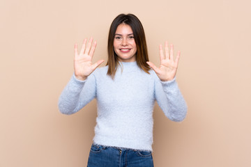 Young woman over isolated background counting ten with fingers