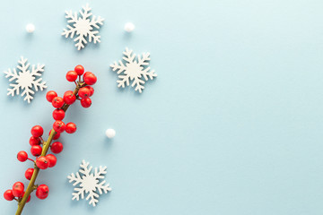 Christmas composition. Snowflake holly berries top view background with copy space for your text....