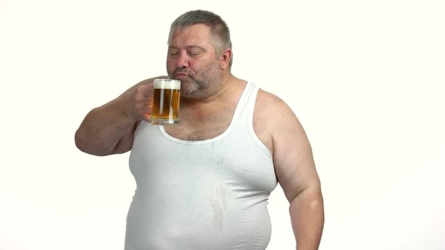 Overweight mature man with beer giving thumb up. Joyful fat guy likes alcohol beverage. Health benefits of beer.