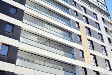 Fragment of modern residential apartment with flat buildings exterior. Detail of new luxury house and home complex. 