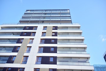 Fragment of modern residential apartment with flat buildings exterior. Detail of new luxury house and home complex. 