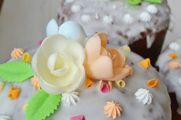 Glazed easter cake with pastel roses on wooden background