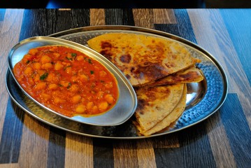 Chana Masala with Paratha, made of chickpeas and selected Indian spices and served with flat bread