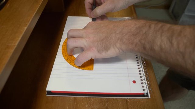 Man using a protractor to draw a circle, doing homework for school.