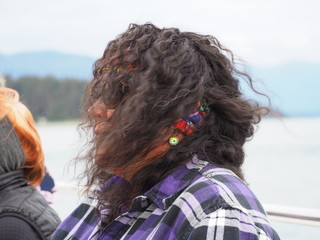 Woman with sunglasses and hair blowing in the wind