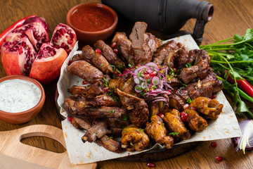 cold and hot meat set on a wooden grate