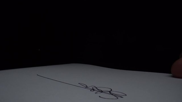 Side view of person heand signs the document. Close-up shot