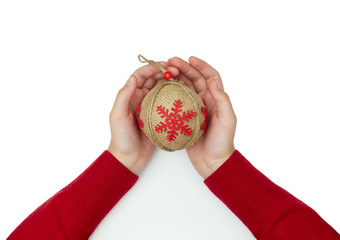 child holding Christmas tree toy ball. on white backgound. New Year background. red snowflake