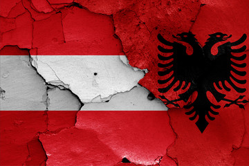 flags of Austria and Albania painted on cracked wall
