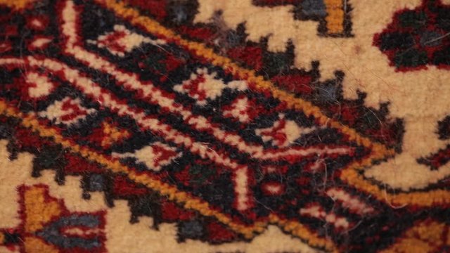 Large oriental rug with colorful patterns. Handmade rug production, carpet close-up with all the details