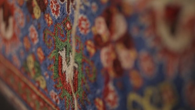 Large oriental rug with colorful patterns. Handmade rug production, carpet close-up with all the details