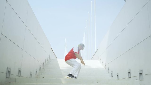 Overweight male hip hop dancer performing on the stair at outdoor. Shot in 4k resolution