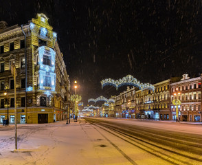 Fototapeta na wymiar Snow-covered and decorated for the New year Nevsky prospect in the early December morning.