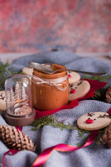 Christmas cookies with homemade salted caramel on a wooden background, neon lights, cinnamon sticks.