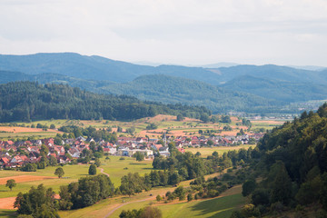 Fototapeta na wymiar Village in mountains. Small German village surrounded with schwarzwald mountains. Calm beautiful place
