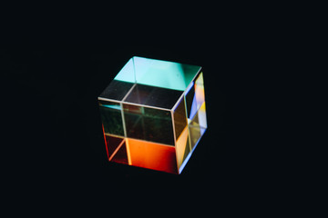 Colorful bright glass prism cube  Refracting light in vivid rainbow colors.