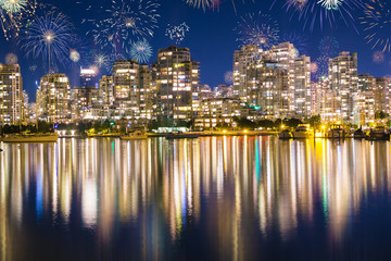 Downtown Vancouver celebrating New Year's Eve with flashing colorful fireworks in British Colombia,...