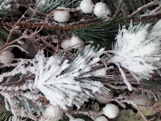 close-up of abstract, bright, Christmas background from a Christmas tree, decorations, snow, berries and fruits
