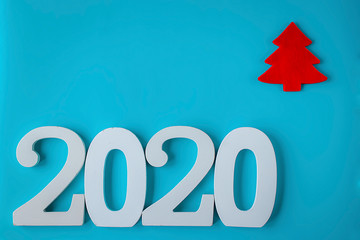 Decorative Christmas red tree and white numbers 2020 on blue background. New Year's and Christmas.