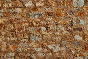 Ancient wall made of rough stone with mortar