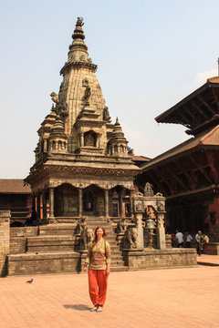 BHAKTAPUR, NEPAL - APRIL 22, 2014: The main attraction of Nepal is the city of Bhaktapur, destroyed by an earthquake. Architecture, carved wooden figures and people walking. UNESCO World Heritage.
