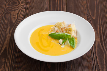 Cheese soup with blue cheese and crouton on dark wooden background
