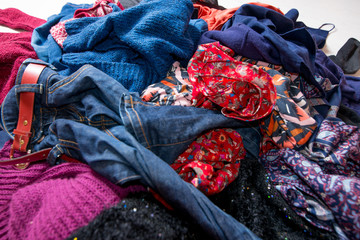 Landfil of used clothes. Pile of scattered second-hand clothes on a white background