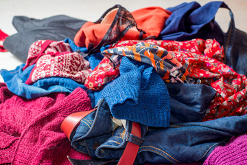 Dump of used clothes. Pile of scattered second-hand clothes on a white background