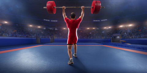 Male athlete is lifting a barbell on a professional stadium. Stadium and crowd are made in 3d.