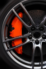 Obraz na płótnie Canvas Prague, Czech Republic - 18 May, 2019: Closeup detail on big orange breaks by Brembo, on a Michelin tire and carbon disk breaks.