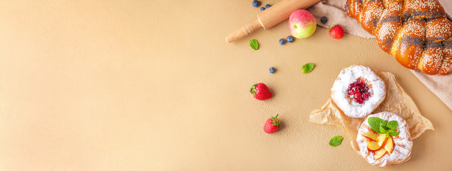 Sweet pastry with fruits on color background