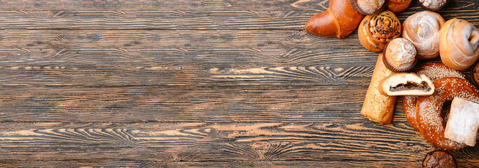 Heap of tasty pastries on wooden background